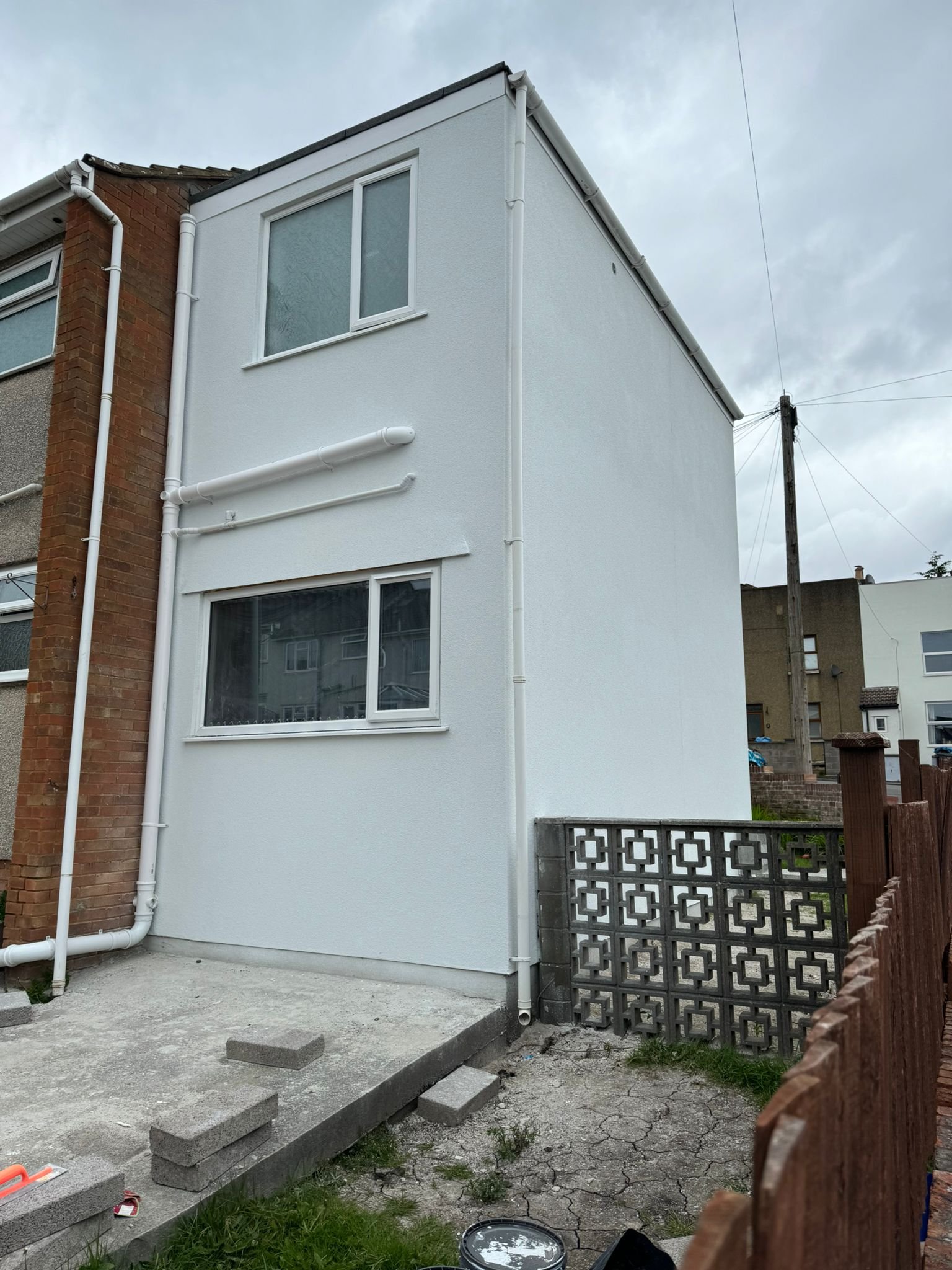 Clean white render finish on exterior wall in Bristol